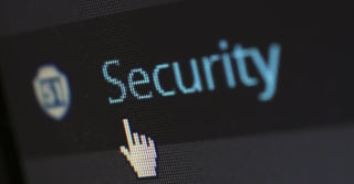 Close up of a computer screen showing a mouse clicking on the word "Security"