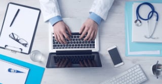 arial view of man typing on a laptop