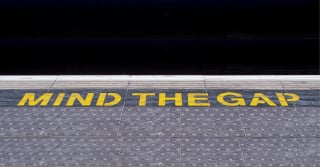 Mind the Gap floor sign at a subway station