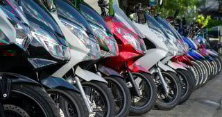 Several motorcycles all lined up in a parking lot