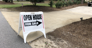 Open House, For Sale sign on a side walk pointing up a driveway