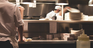 view of busy kitchen at a restaurant