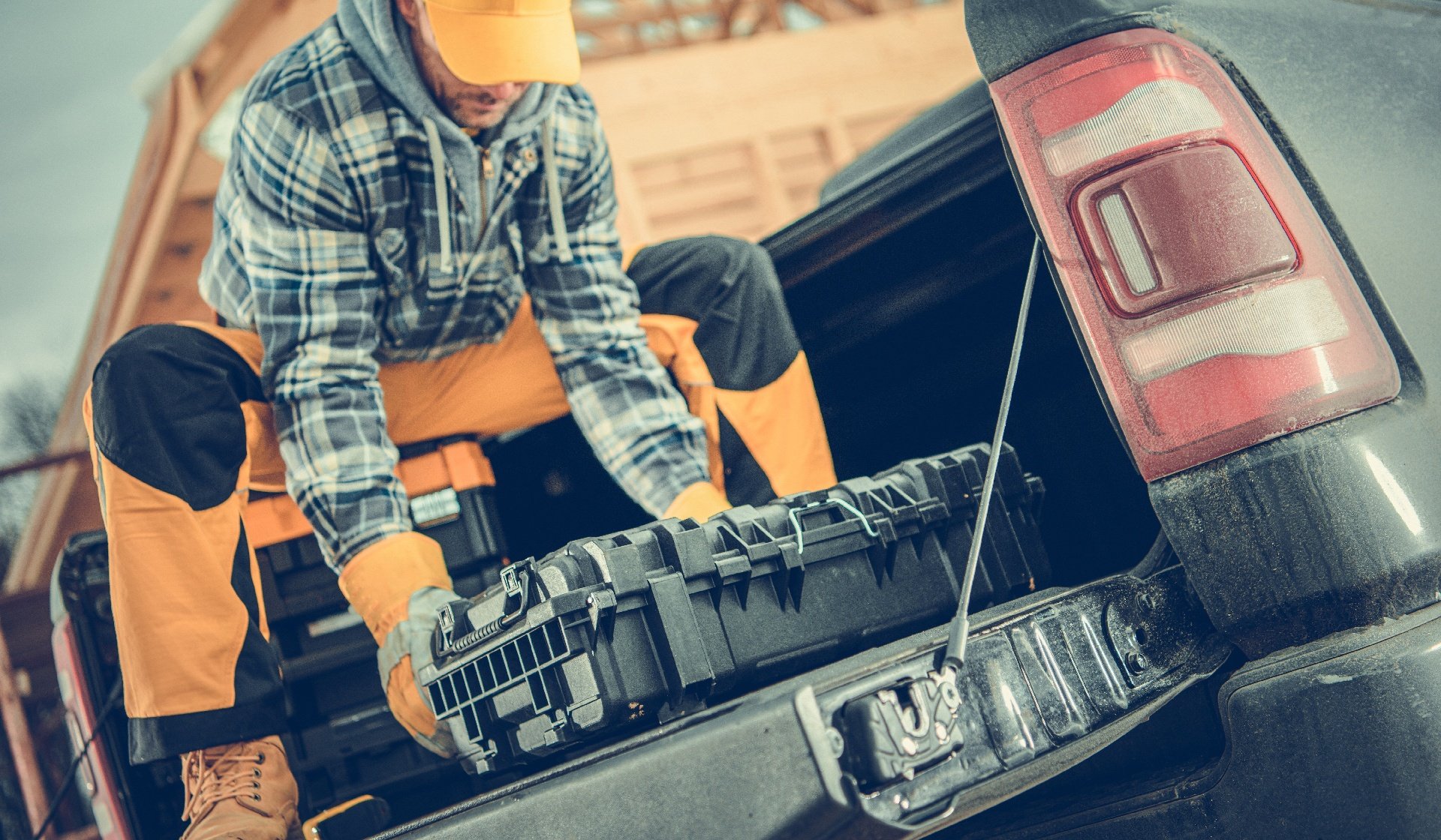 Worker Preparing His Tools on the Pickup Cargo Section